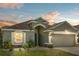 Charming single-story home featuring a neutral color palette, well-maintained landscaping, and an attached two-car garage at 4153 Cortland Dr, Davenport, FL 33837