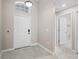 Welcoming foyer featuring neutral-toned tile flooring, a traditional front door, and access to other rooms at 4153 Cortland Dr, Davenport, FL 33837