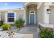 Inviting front entrance featuring a blue door, stone accents, white rock landscaping, and a covered entryway at 4153 Cortland Dr, Davenport, FL 33837