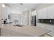 Bright kitchen features white cabinets, stone countertops, stainless steel appliances and modern sink at 4153 Cortland Dr, Davenport, FL 33837