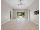 Bright living room with vaulted ceiling, ceiling fan, and slider to the outdoor space at 4153 Cortland Dr, Davenport, FL 33837