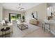Open-concept living room with neutral decor, ceiling fan, and slider to the outdoors at 4153 Cortland Dr, Davenport, FL 33837
