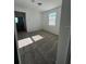 Cozy bedroom with neutral carpet, natural light from the window, and a glimpse into the hallway at 4716 Homestead Trl, St Cloud, FL 34772