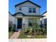 Charming two-story home with a covered front porch and neatly landscaped front yard at 4716 Homestead Trl, St Cloud, FL 34772