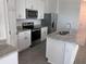 Modern kitchen featuring stainless steel appliances, granite countertops, and white cabinetry at 4716 Homestead Trl, St Cloud, FL 34772