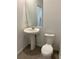 Neat powder room with a pedestal sink, toilet, and tiled floors at 4716 Homestead Trl, St Cloud, FL 34772
