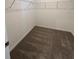 Walk-in closet with carpeted floor and wire shelving for ample storage at 4716 Homestead Trl, St Cloud, FL 34772