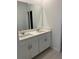 Bathroom with double sink, quartz countertops and modern cabinetry at 4720 Homestead Trl, St Cloud, FL 34772
