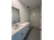 Modern bathroom featuring a sleek vanity with a quartz countertop and a tiled shower-over-tub at 4720 Homestead Trl, St Cloud, FL 34772