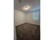 A simple bedroom with neutral carpet and a window for natural light at 4720 Homestead Trl, St Cloud, FL 34772