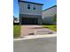 Two-story home with gray siding and brick driveway at 4720 Homestead Trl, St Cloud, FL 34772