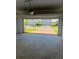 An empty two-car garage looking out on a brick driveway and two-story homes at 4720 Homestead Trl, St Cloud, FL 34772