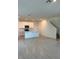 Open-concept kitchen features white cabinets, an island, and sleek tile flooring at 4720 Homestead Trl, St Cloud, FL 34772
