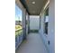 A cozy, grey-toned front porch with modern railings and a peaceful outdoor space at 4720 Homestead Trl, St Cloud, FL 34772