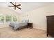 A bedroom with vaulted ceiling, carpeting, a ceiling fan and a lovely view from the multiple windows at 5037 Hawkstone Dr, Sanford, FL 32771