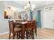 Dining area features seating for six, a modern light fixture and view into the kitchen at 5037 Hawkstone Dr, Sanford, FL 32771