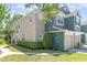 Two-story townhome showing manicured shrubs and healthy green lawn on a bright, sunny day at 5037 Hawkstone Dr, Sanford, FL 32771