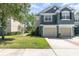 Charming two-story townhome with attached garages, lush lawn, and well-maintained landscaping in a quiet community at 5037 Hawkstone Dr, Sanford, FL 32771