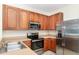 Kitchen showcases stainless steel appliances, warm wood cabinets and ample counter space for meal prep at 5037 Hawkstone Dr, Sanford, FL 32771
