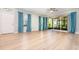 Bright, open living room with laminate flooring, ceiling fan, large sliding doors leading to screened patio at 5037 Hawkstone Dr, Sanford, FL 32771