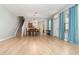 Open concept living room and dining area with laminate flooring and staircase access to upper level at 5037 Hawkstone Dr, Sanford, FL 32771
