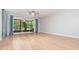 Spacious, light-filled living room with laminate flooring, ceiling fan and glass sliding doors to the patio at 5037 Hawkstone Dr, Sanford, FL 32771