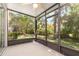 Enclosed back patio features a ceiling fan and views of the landscaped backyard at 5037 Hawkstone Dr, Sanford, FL 32771