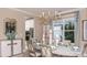 Elegant dining room featuring a chandelier and seating for six at 5223 Quillback Ln, St Cloud, FL 34771