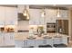 A modern kitchen with stainless steel appliances, white cabinets, and a granite island at 5223 Quillback Ln, St Cloud, FL 34771
