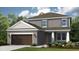Charming two-story home features a neutral color palette, a two car garage and a welcoming front entrance at 5229 Quillback Ln, St Cloud, FL 34771