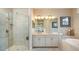 Modern bathroom featuring a glass shower, double sinks, and plenty of counter space at 5259 Quillback Ln, St Cloud, FL 34771