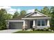 Charming single-Gathering home featuring stone accents, a two-car garage, and a covered front porch at 5259 Quillback Ln, St Cloud, FL 34771