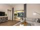 Comfortable living room featuring hardwood floors, plush seating, and sliding glass doors to the patio at 5259 Quillback Ln, St Cloud, FL 34771