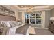 Serene primary bedroom with elegant decor and a view of the screened-in pool at 5259 Quillback Ln, St Cloud, FL 34771