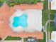 Overhead view of refreshing in-ground pool with poolside seating at condo at 5300 S Atlantic Ave # 6-301, New Smyrna Beach, FL 32169