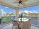 The screened-in balcony features a ceiling fan and seating and boasts beautiful views of the surrounding area at 5300 S Atlantic Ave # 6-301, New Smyrna Beach, FL 32169
