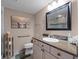 Bathroom featuring granite counters, tile flooring, and a decorative mirror at 5300 S Atlantic Ave # 6-301, New Smyrna Beach, FL 32169
