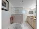 A modern bathroom featuring a soaking tub with tile surround and a glass enclosed shower at 5300 S Atlantic Ave # 6-301, New Smyrna Beach, FL 32169