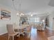 Sunlit dining room open to living area boasts hardwood floors and stylish furnishings at 5300 S Atlantic Ave # 6-301, New Smyrna Beach, FL 32169