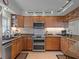 A kitchen featuring a stainless steel double oven, tile backsplash, and granite countertops at 5300 S Atlantic Ave # 6-301, New Smyrna Beach, FL 32169