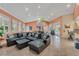 Spacious living room with a comfortable sectional sofa, abundant natural light, and stylish tile flooring at 5300 S Atlantic Ave # 6-301, New Smyrna Beach, FL 32169