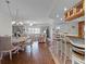 Open-concept living/dining room featuring beachy decor, wood-look floors, and ample natural light at 5300 S Atlantic Ave # 6-301, New Smyrna Beach, FL 32169