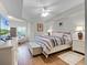 The bedroom features hardwood floors, a ceiling fan, and a large window providing natural light at 5300 S Atlantic Ave # 6-301, New Smyrna Beach, FL 32169