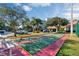 Community shuffleboard court surrounded by lush landscaping, offering recreational opportunities and a park-like setting at 5300 S Atlantic Ave # 6-301, New Smyrna Beach, FL 32169