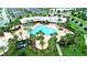 Aerial view of a community pool, surrounded by lush landscaping, offering a resort-like experience at 5711 Hamlin Groves Trl, Winter Garden, FL 34787