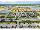 Aerial view of a neighborhood with multiple homes near a lake in a Gathering-friendly community at 5711 Hamlin Groves Trl, Winter Garden, FL 34787