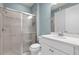 Bright bathroom featuring a tiled shower with glass doors, vanity and a toilet at 5711 Hamlin Groves Trl, Winter Garden, FL 34787