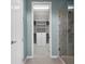 Bathroom featuring a glass shower and a walk-in closet with custom shelving and drawers at 5711 Hamlin Groves Trl, Winter Garden, FL 34787