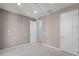 Bright bedroom with neutral carpet, trim, and paint, featuring two doors, offers a versatile and inviting space at 5711 Hamlin Groves Trl, Winter Garden, FL 34787
