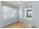 Bright bedroom with hardwood floors and white shutters, creating a welcoming and airy atmosphere at 5711 Hamlin Groves Trl, Winter Garden, FL 34787